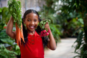 girl holding produce